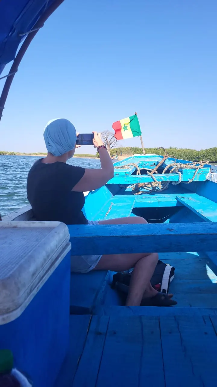 Souvenir photo in a pirogue with the Senegal flag