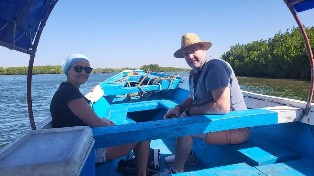 Couple in a blue pirogue on the Somone lagoon